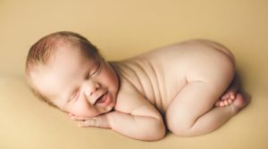 Fort Collins, Colorado Newborn Baby Photographer posed on yellow